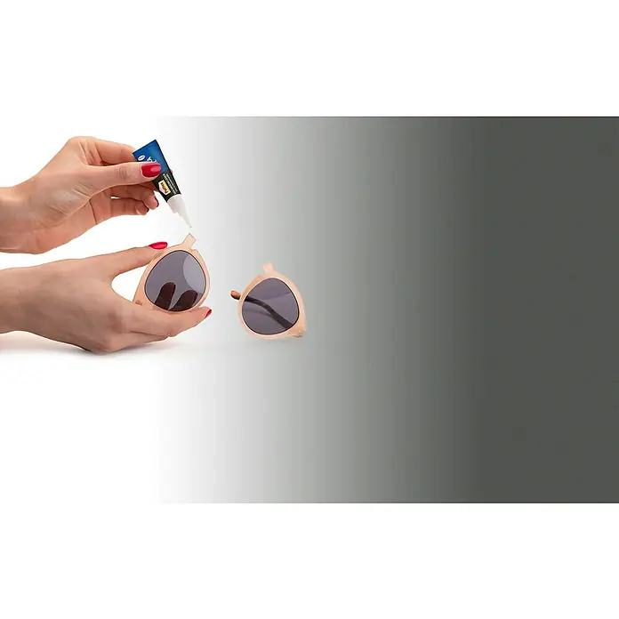 Pattex Sekundenkleber Ultra Gel - 3 g, Tube, Gelartig, 1 Stk. - Hände kleben eine kaputte Sonnenbrille mit einem kleinen Klebstofftube, um sie zu reparieren. Sonnenbrille wird dadurch wieder funktionstüchtig.