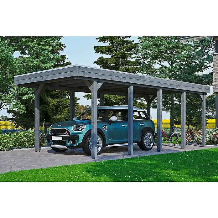 SKAN HOLZ Carport Friesland - Außenmaß inkl. Dachüberstand (B x T): 3,14 x 7,08 m, Einzelcarport, Schiefergrau, Material Dach: Holz - Das Bild zeigt ein modernes Carport mit einem blauen Mini Cooper darunter, umgeben von einer grünen Rasenfläche und üppiger Vegetation.