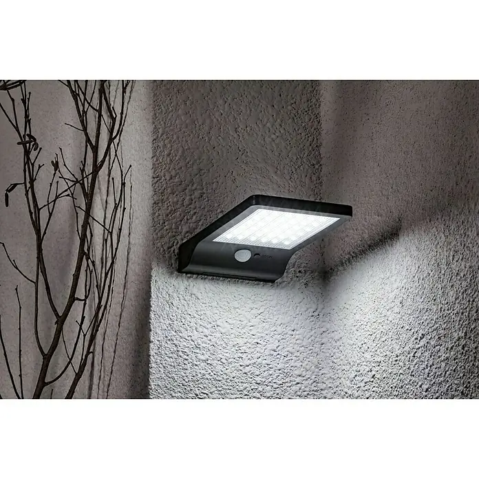 BAUHAUS Solar-Außenwandleuchte - 3 W, L x B x H: 19 x 11 x 3 cm, Schwarz, IP44, 300 lm - Wandleuchte mit Solarpanel, die an einer Wand montiert ist und ein helles Licht abgibt. Ideal für den Außenbereich, um Energie zu sparen.