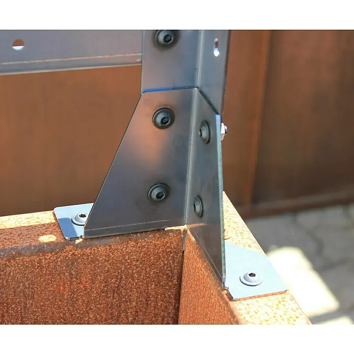 Palatino Rankhilfe - Cortenstahl, Passend für: Palatino Urban Hochbeet L-Form, Höhe: 113 cm - Nahaufnahme eines Metallverbindungsstücks, das mit Schrauben an einem rostfarbenen Metallrahmen befestigt ist. Das robuste Design betont die Haltbarkeit.