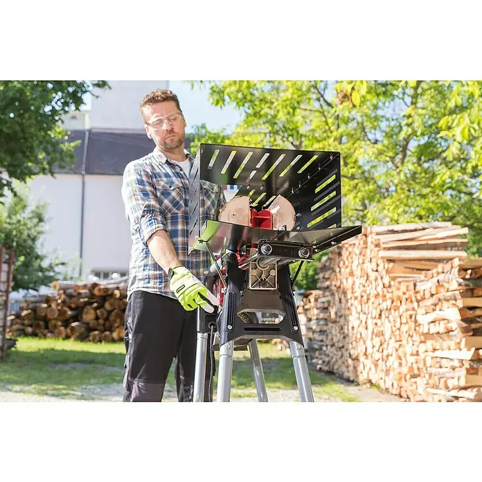 AL-KO Easy Holzspalter LSH 520/5 - 2.200 W, 5 t, Max. Spaltgutlänge: 52 cm - Ein Mann bedient einen Holzspalter mit Schutzvorrichtung, im Hintergrund Holzstapel. Geeignet für schnelles und sicheres Zerkleinern von Brennholz.