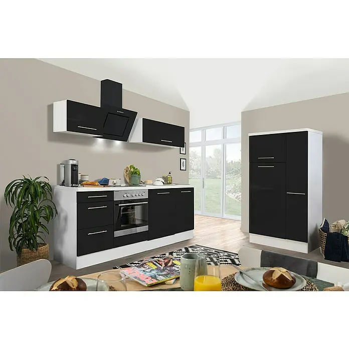 Respekta Premium Composición de cocina Amanda Alto - Ancho: 310 cm, Blanco/Negro, Con electrodomésticos - Una cocina moderna con frentes negros brillantes y paneles laterales blancos, campana extractora y una mesa de comedor en primer plano.