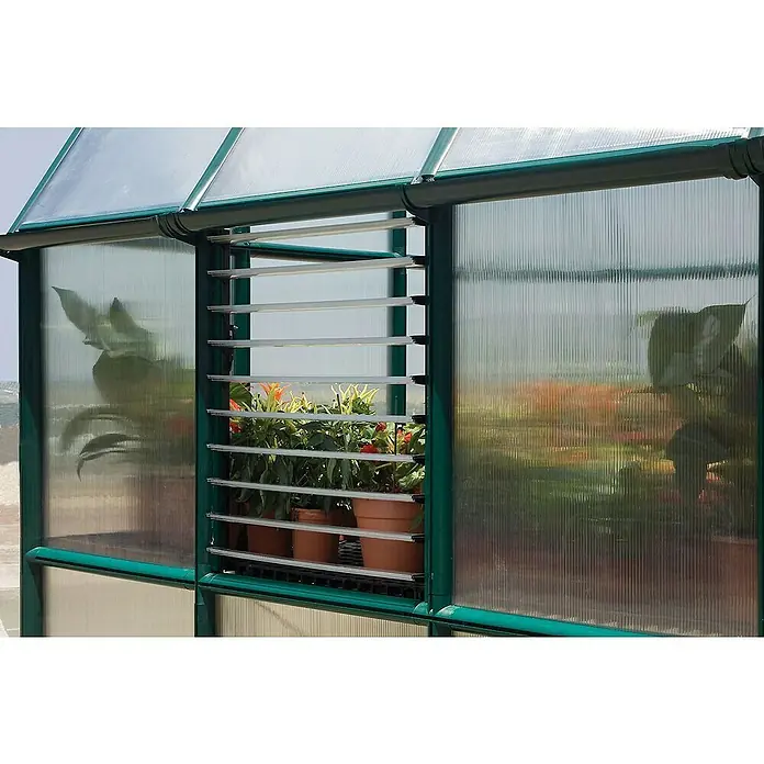 Palram – Canopia Ventana lateral para invernadero - Específico para: invernaderos Palram - Canopia - Una vista cercana de un invernadero con plantas visibles a través de las ventanas de persiana, integrándose perfectamente en la estructura.