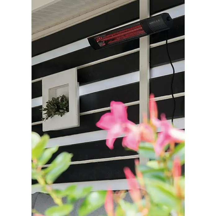 Sunred Royal Diamond Wandheizstrahler Dark - 2.500 W, 81,7 x 10 x 14,1 cm - Nahaufnahme einer an der Wand montierten Sunred-Terrassenheizung mit Heizstäben und Kabel auf einer schwarz-weiß gestreiften Wand.