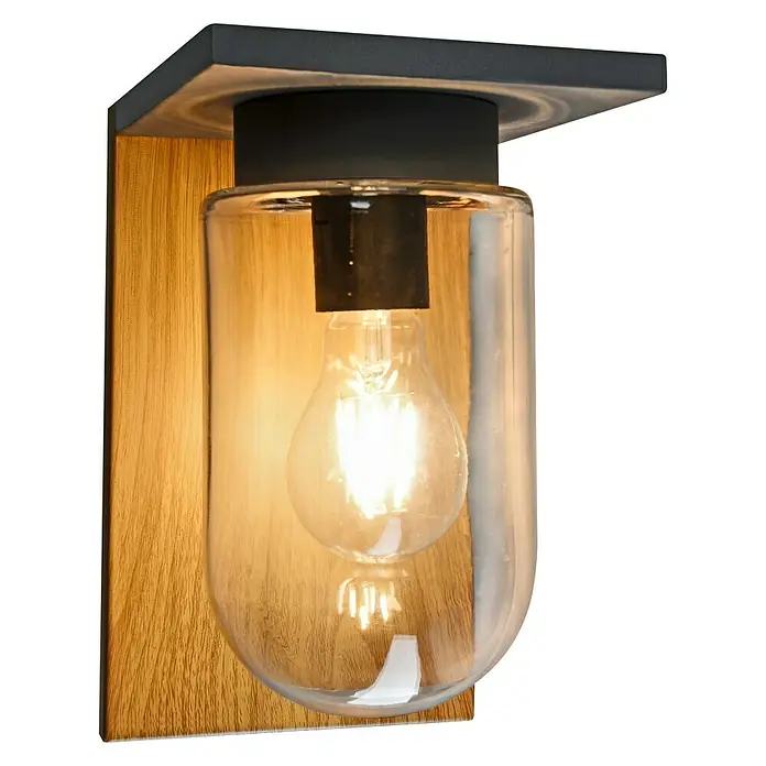 Starlux Außenwandleuchte Elua - 40 W, 19 x 14 x 23 cm, Holz, Grau, IP44 - Nahaufnahme einer Wandleuchte mit Holzsockel, schwarzem Befestigungselement und einer klaren Glasglocke, die eine Glühbirne enthält.