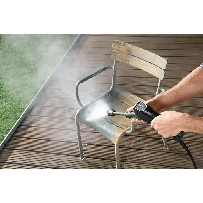 Kärcher Hochdruckreiniger K 3 Power Control - 120 bar, 1.600 W, Fördermenge: 380 l/h - Ein Hochdruckreiniger säubert einen rostigen Stuhl auf einer Holzterrasse, wobei der Fokus auf der Reinigungswirkung des Geräts liegt.