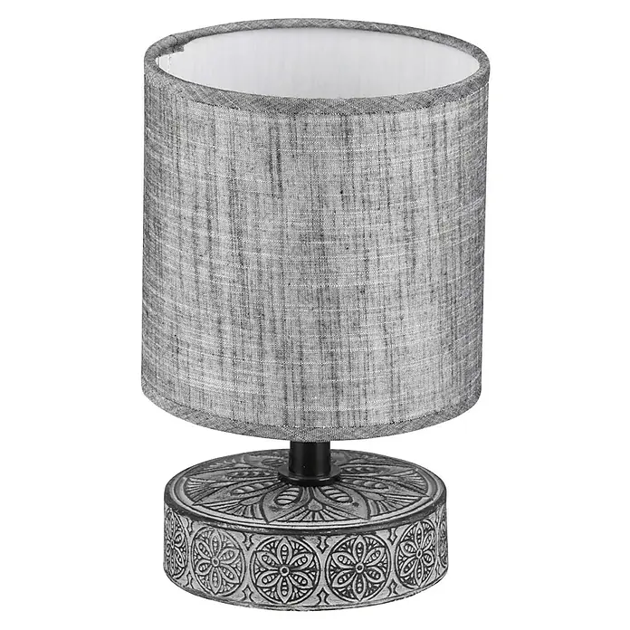 Trio Lighting Lámpara de sobremesa redonda Marie - 28 W, Ø x Al: 13 x 20,5 cm, Gris, E14 - Primer plano de una lámpara de mesa gris con una base decorativa y una pantalla de tela sencilla.
