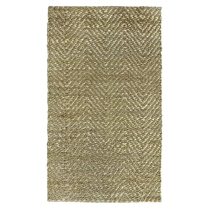 Alfombra de yute Alcázar - Natural, 230 x 160 cm, 100% yute - Primer plano de una alfombra rectangular de tejido beige grueso con un patrón de espiga, destacando la textura y la artesanía.