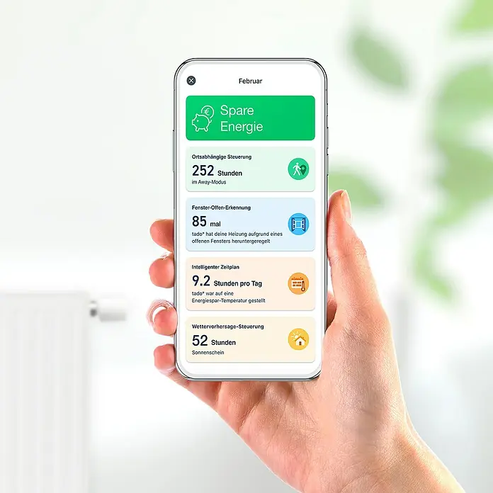 Tado Smartes Termostato de radiador Duo pack - M30 x 1,5 mm, 2 ud. - Teléfono inteligente que muestra una aplicación de ahorro de energía, mostrando estadísticas de febrero, centrándose en el control y el consumo de energía.