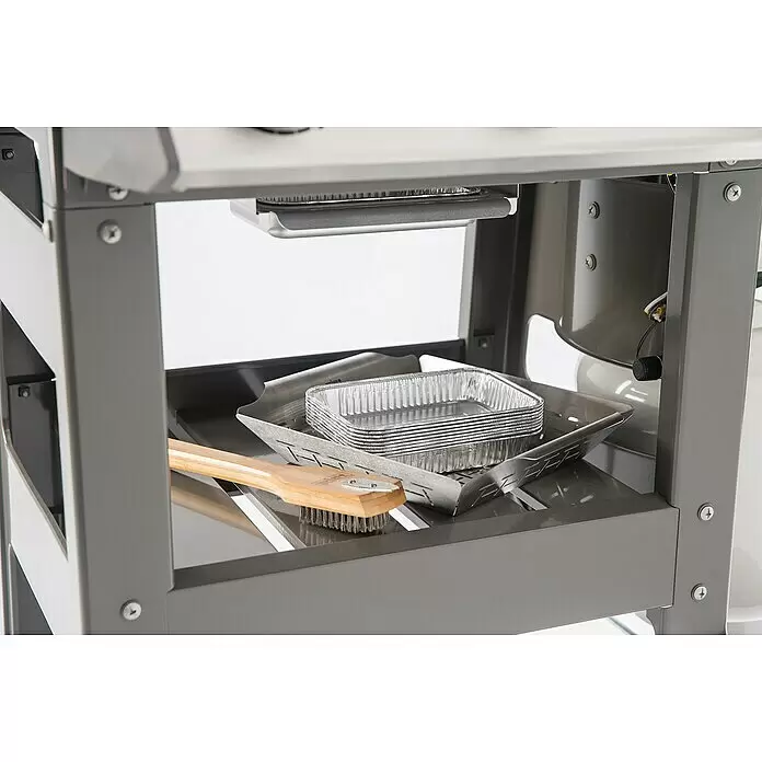 Weber Barbacoa de gas Spirit II E-310 + 7 accesorios - Superficie de la parrilla (An x Pr): 60 x 46 cm, 8,7 kW, Número de quemadores: 3 - Estante inferior de un carrito de parrilla gris con moldes de papel de aluminio apilados, una herramienta de metal y un cepillo de parrilla de madera.