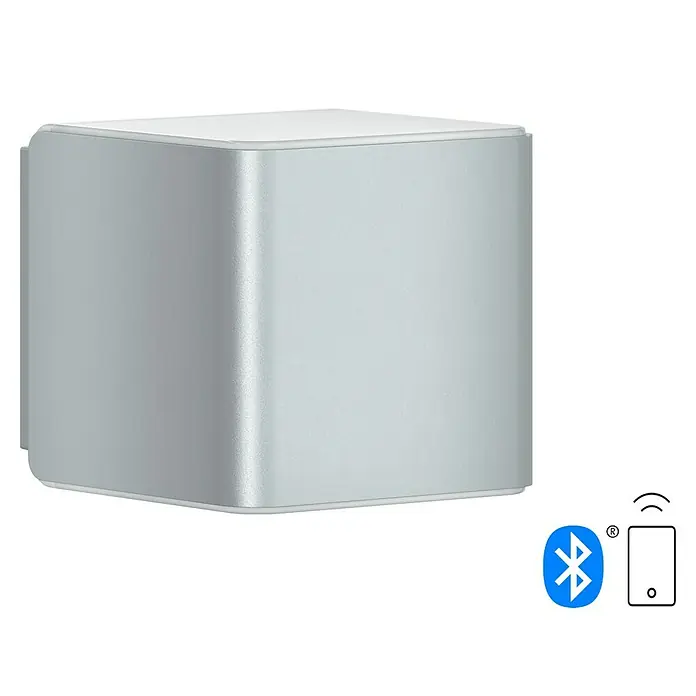 Steinel Aplique exterior LED L 840 SC - 9,1 W, 13,4 x 11 x 11 cm, Plateado, IP44 - Un altavoz Bluetooth plateado en forma de caja con bordes redondeados y conectividad inalámbrica a un smartphone.