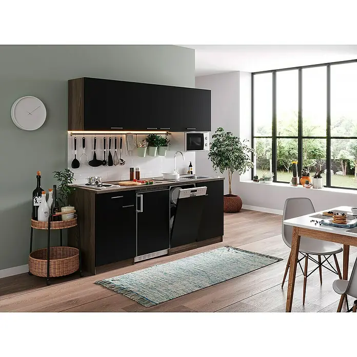 Respekta Singleküche Oliver - Breite: 195 cm, Schwarz, Mit Duo-Kochmulde und Mikrowelle - Eine moderne Küche mit schwarzen Schränken, einer weißen Spüle und einer Kücheninsel aus Holz. Ein weißer Esstisch steht daneben.