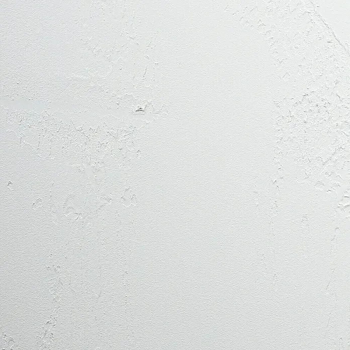 SCHÖNER WOHNEN-Farbe Betondesign-Optik Versiegelung - Creme, 1 l, Passend für: SCHÖNER WOHNEN-Farbe Betondesign-Optik Flächenspachtel - Nahaufnahme einer weißen Wand mit unebener Textur, ideal als neutraler Hintergrund oder zur Hervorhebung von Oberflächenstrukturen.