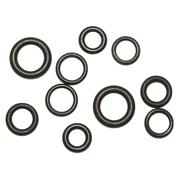 O-Ring-Sortiment - 10 Stk., Gummi - Diese Aufnahme zeigt eine Anordnung von Dichtungsringen auf einem schwarzen Hintergrund, die eine Vielzahl von Größen und Konfigurationen aufweist.