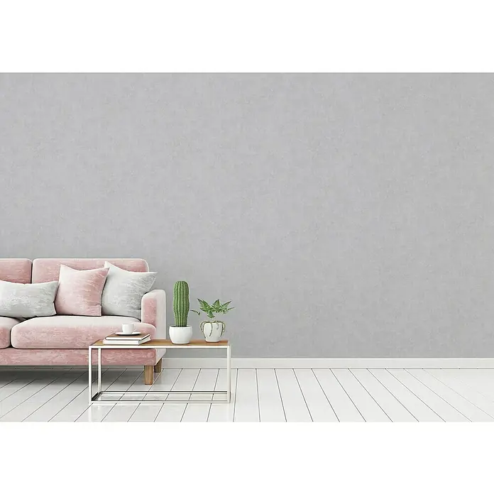 A.S. Création History of Arts Vliestapete - Blau/Grau, Uni, 10,05 x 0,53 m - Minimalistisches Wohnzimmer mit rosa Sofa, Tisch mit Kaktus und Pflanzen vor einer grauen Wand.