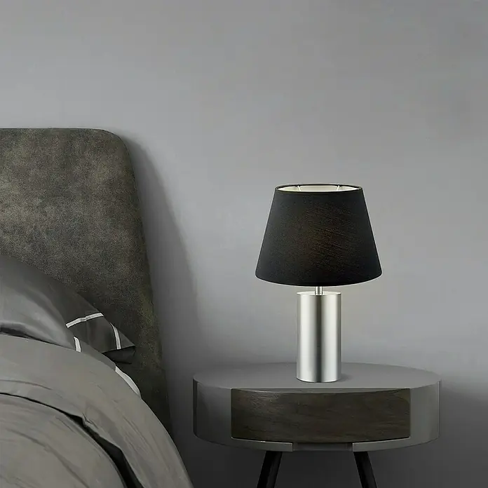 Home Sweet Home Lampenschirm Largo - Ø x H: 24 x 16 cm, Night Black, Stoff, Oval - Elegante Nachttischlampe mit schwarzem Lampenschirm und silbernem Sockel auf einem grauen Nachttisch.