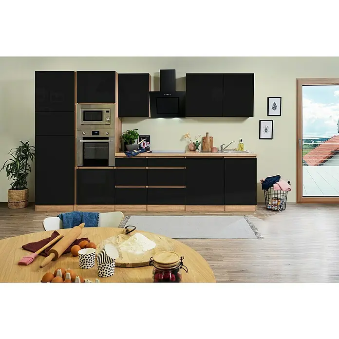 Respekta Premium Küchenzeile Lorena - Breite: 345 cm, Schwarz, Hochglänzend, Dekor Arbeitsplatte: Holzoptik, Mit Elektrogeräten - Helle Küche mit schwarzen Schränken und Geräten, ergänzt durch eine hölzerne Arbeitsfläche und einen Holztisch mit Backutensilien.