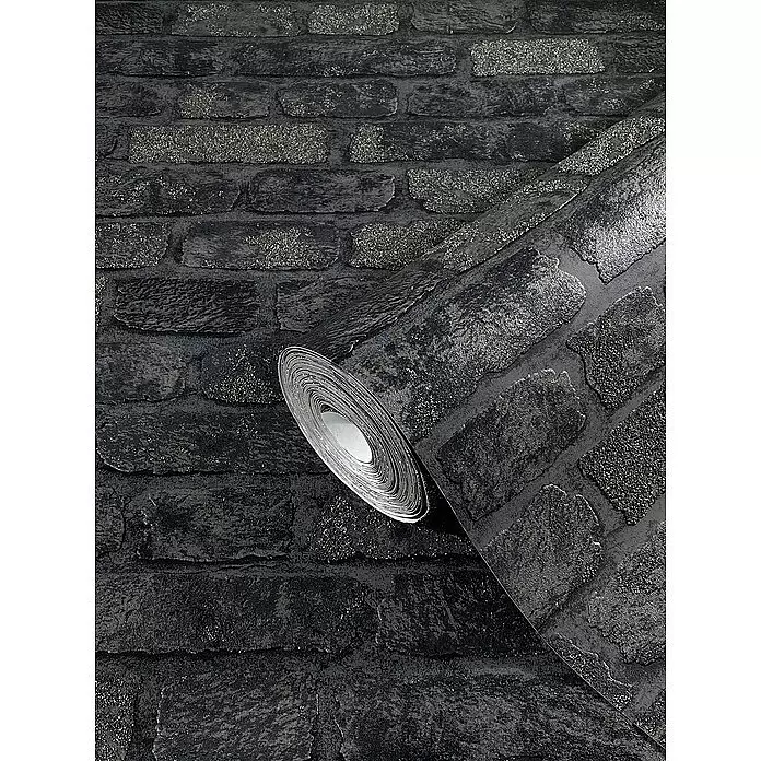 Marburg Sand & Stones Vliestapete Steinmauer I - Grau/Dunkelgrau, Steinoptik, 10,05 x 0,53 m - Dunkle, glitzernde Ziegelstein-Tapetenrolle, teilweise abgerollt.