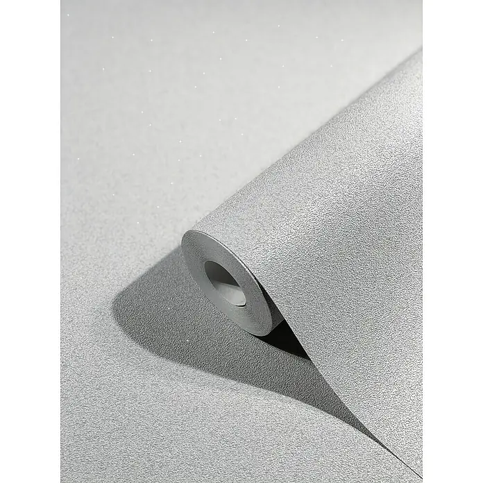SCHÖNER WOHNEN-Kollektion New Spirit Vliestapete - Silbergrau, Uni, 10,05 x 0,53 m - Nahaufnahme einer Rolle schimmernder, silberfarbener Glitzertapete, die eine elegante und moderne Atmosphäre in jedem Raum schafft.