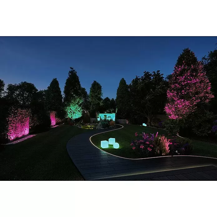 Paulmann Plug & Shine Basis-Set LED-Gartenstrahler Pike Smart Home Zigbee 3.0 - Anthrazit, Ø x H: 5 x 22,5 cm, 4,5 W, Per App steuerbar, IP44, 3 Stk. - Farbenfrohe LED-Beleuchtung erhellt nachts einen gewundenen Gartenweg, leuchtende Würfel auf dem Rasen sowie Bäume und Wände in leuchtendem Pink, Grün und Cyan.