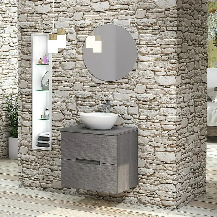 Artysan Conjunto de mueble de baño Loop Top - Ancho: 60 cm, 4 pzs., Ceniza, Mate - Un moderno tocador de baño con un gabinete gris, espejo redondo y lavabo sobre encimera, todo sobre una pared de piedra.