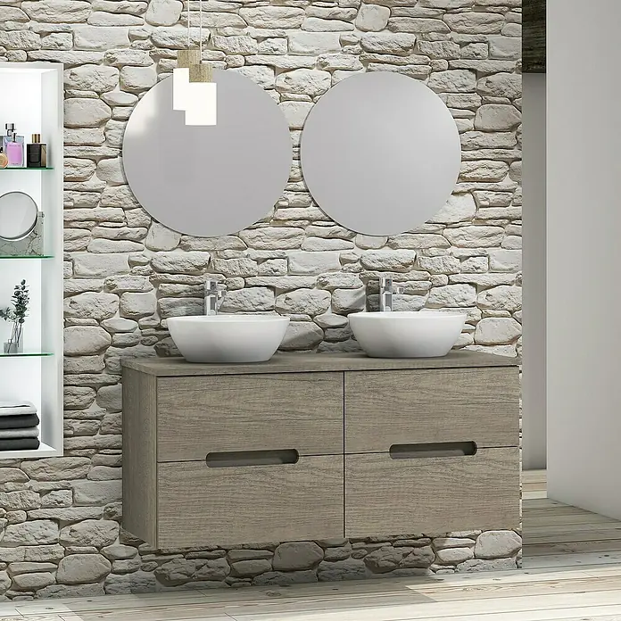 Artysan Conjunto de mueble de baño Loop Top - 6 pzs., Nebraska, Mate - Mueble de baño con dos espejos redondos y pared de piedra natural. Mueble de madera gris con cajones y lavabos sobre encimera blancos.