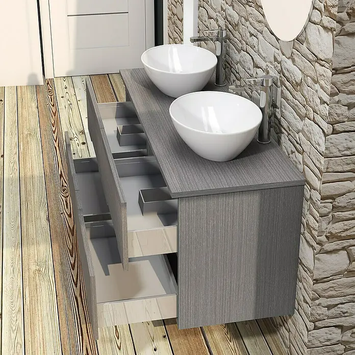 Artysan Conjunto de mueble de baño Loop Top - 6 pzs., Ceniza, Mate - Mueble de baño gris con dos lavabos y cajones abiertos sobre un suelo de madera, frente a una pared de piedra.