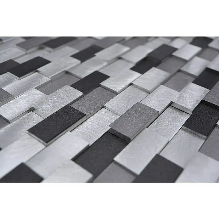 Mosaikfliese Brick 3D Mix XAM A132 - 30,1 x 30,4 cm, Silber/Schwarz, Matt - Nahaufnahme eines Musters aus modernen, rechteckigen Wandfliesen in Silber-, Grau- und Schwarztönen. Elegante Wandverkleidung für stilvolle Innenräume.