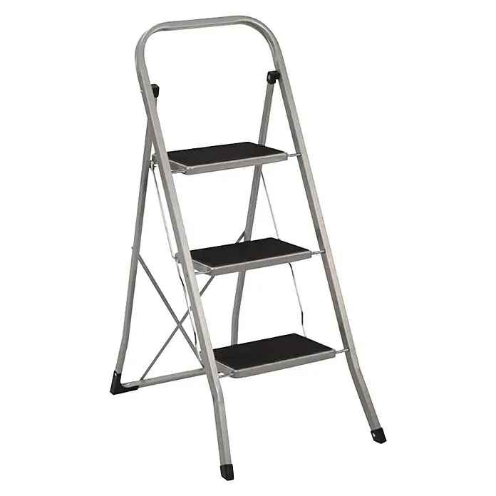 Escalerilla plegable - Número de peldaños: 3 ud., Altura de trabajo: 2,7 m, Carga soportada: 150 kg, Metal - Imagen de una escalera doméstica plateada con tres peldaños y un asa, perfecta para tareas en casa.