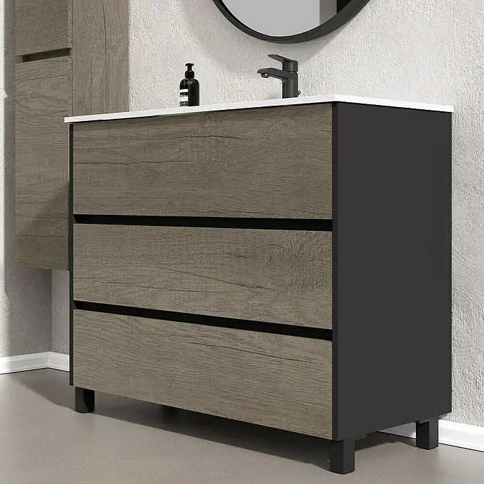 Artysan Conjunto de mueble de baño Africa - Ancho: 100 cm, 3 pzs., Nebraska, Mate - Un mueble de baño con tres cajones de aspecto madera y marco negro, con una encimera blanca y grifo minimalista.