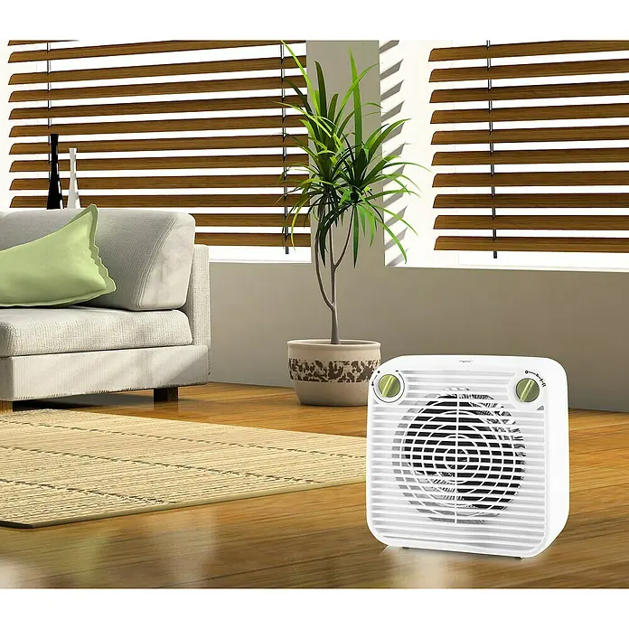 Voltomat HEATING Heizlüfter Transisto - 1.000 W - 2.000 W, Weiß - Abbildung eines weißen Heizlüfters mit Drehreglern und einem Schutzgitter vor einem Wohnzimmerhintergrund.