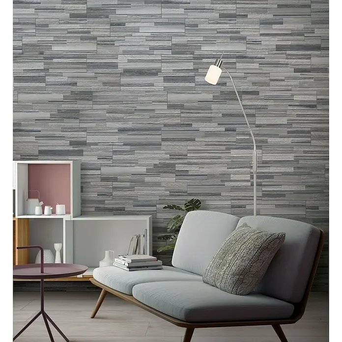 Tween Light LED-Leseleuchte Aruba - 159 cm, Anzahl Leuchtmittel: 1 Stk. - Aufnahme eines modernen Wohnraums mit einer Akzentwand aus grauen Steinfliesen, die dem Raum Textur und Tiefe verleiht.