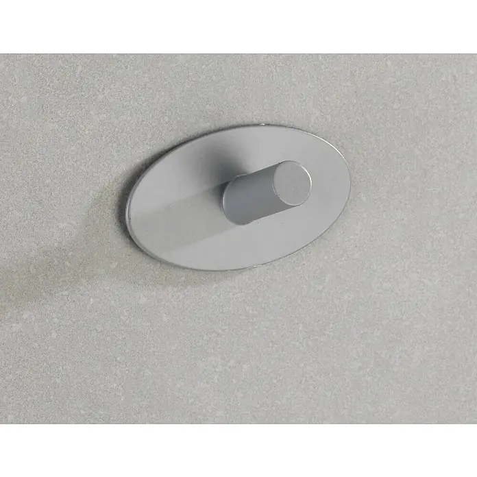 Wenko Handtuchhaken Piceno - 2 Stk., Edelstahl, Edelstahl - Nahaufnahme eines silbernen Wandhakens mit rundem Design auf einer hellgrauen, leicht strukturierten Oberfläche.