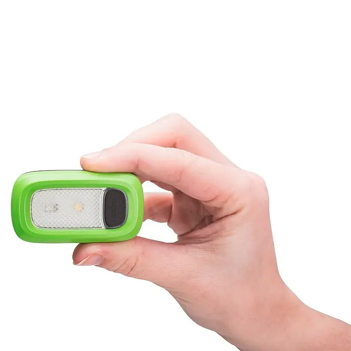 Energizer Linterna deporte - 2,25 x 10,8 x 16,5 cm, 30 lm, IPX4 - Una mano sosteniendo una linterna frontal verde con un botón negro y una luz blanca. Práctica y compacta para llevar.