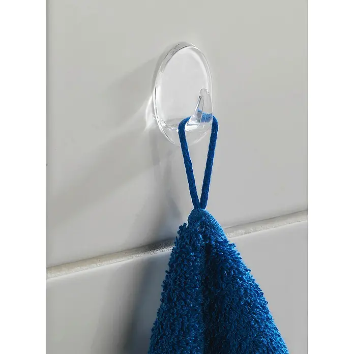 Wenko Handtuchhaken Zwerghaken - 6 Stk., Transparent, Kunststoff - Ein blauer Handtuch hängt an einem transparenten Klebehaken an einer weißen Wand. Das Handtuch ist weich und flauschig.
