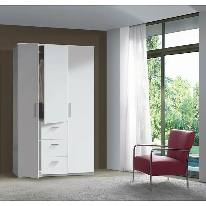 Armario para ropa Ward - L x An x Al: 52 x 117 x 203 cm, Blanco - Esta imagen muestra un armario blanco moderno con cajones, parcialmente abierto, en una habitación luminosa con alfombra y sillón.