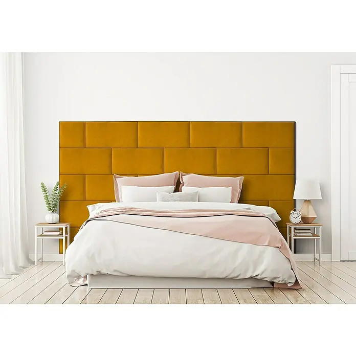 Fllow Wandpolster-Set Velvet A1 - 270 x 150 cm, Ocker - Schlafzimmer mit einem Bett mit einem senfgelben Wandpaneel-Kopfteil, weißen Laken und rosa Akzenten.