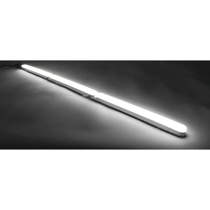 Ritter Leuchten LED-Unterbauleuchte FlexLight Add On - 3,4 W, Länge: 32,4 cm, Warmweiß - Das Bild zeigt eine lange, moderne LED-Lampe, die helles, weißes Licht abgibt. Die Lampe ist in mehrere Segmente unterteilt und liegt auf einer grauen Oberfläche.