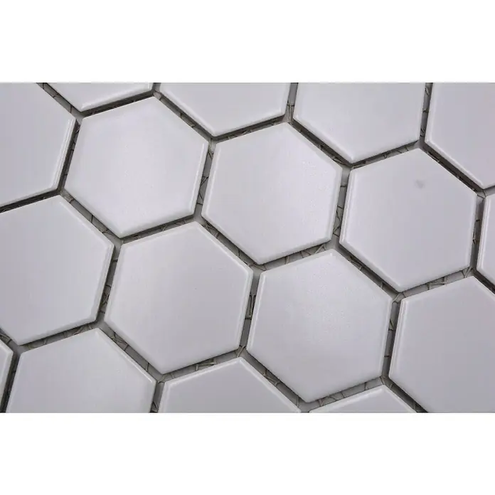 Mosaikfliese Hexagon Uni HX 085 - 32,5 x 28,1 cm, Weiß, Matt - Nahaufnahme von weißen sechseckigen Fliesen, die ein geometrisches Muster bilden und eine moderne, elegante Oberfläche für Wände und Böden schaffen.