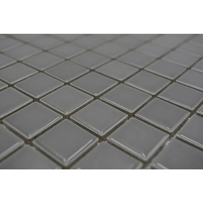 Mosaikfliese Quadrat Uni CG 124 - 29,8 x 29,8 cm, Grau, Glänzend - Nahaufnahme von grauen quadratischen Keramikfliesen, die ein sich wiederholendes Muster bilden und ein modernes, elegantes Design zeigen.
