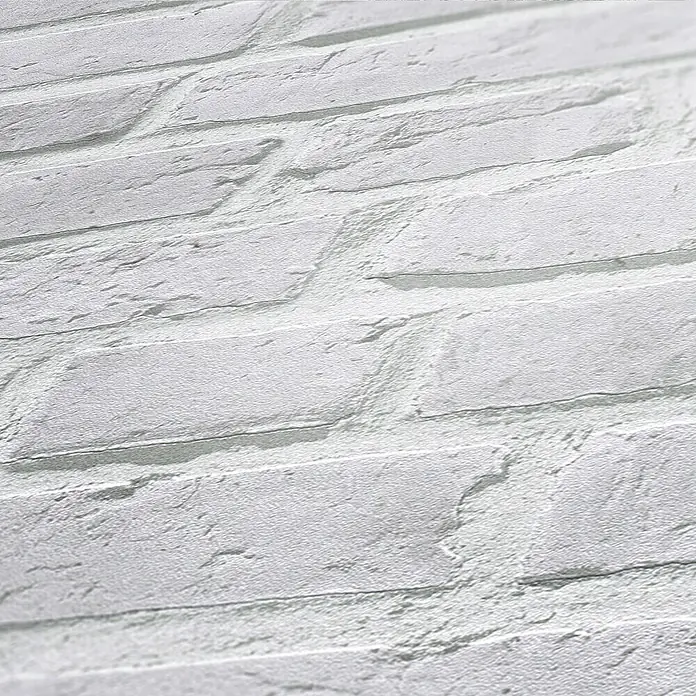 A.S. Création Elements Vliestapete Mauerwerk - Hellgrau, Steinoptik, 10,05 x 0,53 m - Nahaufnahme einer weißen Backsteinmauer, die die Textur und Details der einzelnen Steine hervorhebt, ideal für Hintergründe und Texturen.
