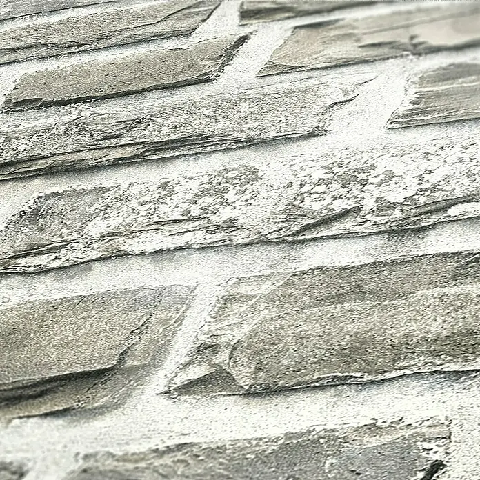 A.S. Création Elements Vliestapete Steine - Creme/Grau, Steinoptik, 10,05 x 0,53 m - Nahaufnahme einer grauen Steinwand, die Textur und Tiefe zeigt. Ideal für Hintergründe, Texturen oder Bauprojekte.