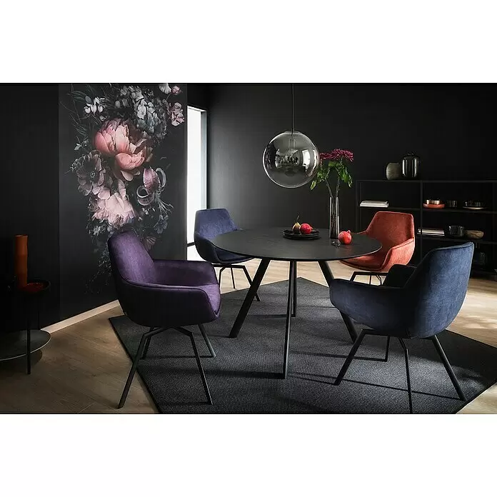 SCHÖNER WOHNEN-Kollektion New Spirit Fototapete Digitaldruck Blumenstrauß - 159 x 270 cm - Ein modernes Esszimmer mit einem runden schwarzen Tisch und gepolsterten Stühlen in Lila, Blau und Terrakotta vor einer floralen Wandmalerei.