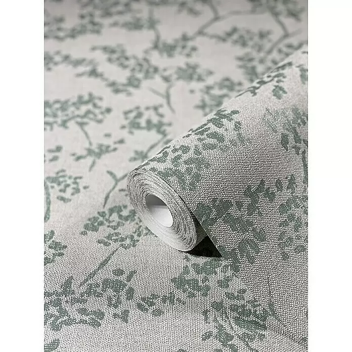 SCHÖNER WOHNEN-Kollektion New Spirit Vliestapete Blüten-Allover - Beige/Blau, Floral, 10,05 x 0,53 m - Teilweise abgerollte, strukturierte Tapetenrolle in Hellgrau mit grünlichem Blumenmuster.