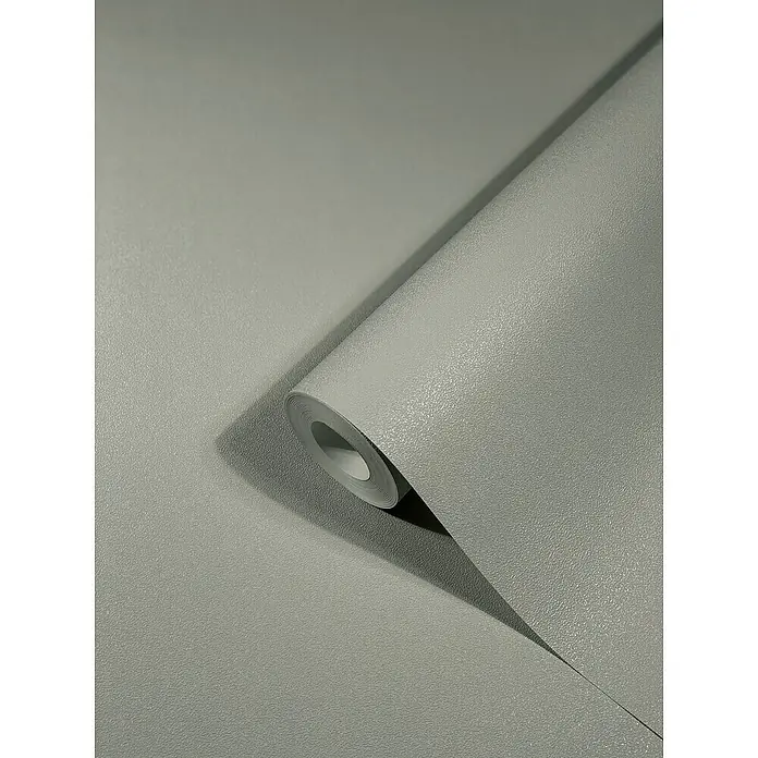 SCHÖNER WOHNEN-Kollektion New Spirit Vliestapete - Schimmergrau, Uni, 10,05 x 0,53 m - Nahaufnahme einer Rolle grauer, texturierter Vinyltapete, die eine elegante und robuste Wanddekoration für jeden Raum darstellt.