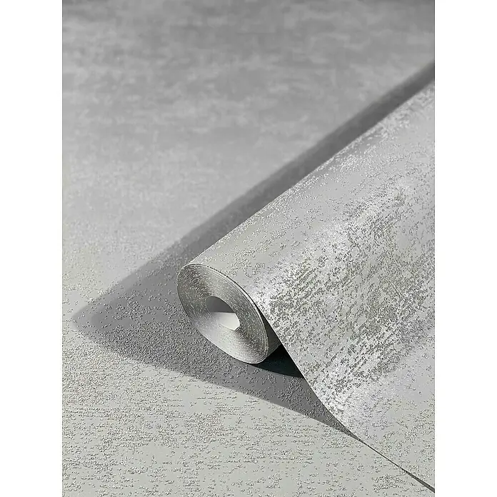 Marburg Sand & Stones Vliestapete Dune II - Dunkelgrau, Uni, 10,05 x 0,53 m - Nahaufnahme einer Rolle grauer Tapete mit subtiler Textur, die ein modernes und elegantes Design für die Wandgestaltung zeigt.