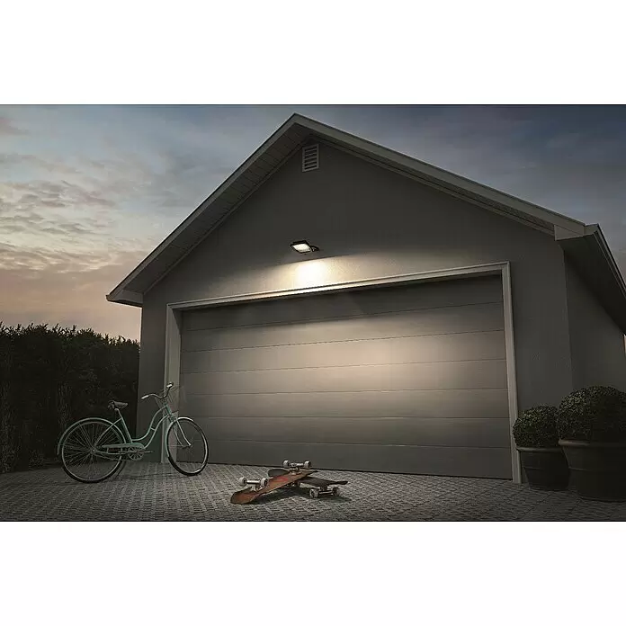 Ledvance LED-Strahler - 100 W - Dunkle Außenleuchte beleuchtet Garageneingang in der Dämmerung.