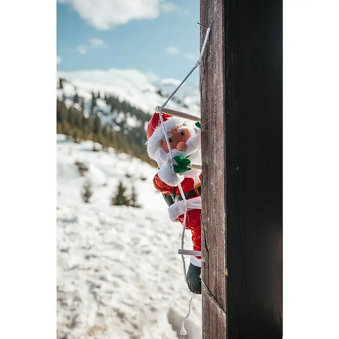 LED-Weihnachtsdekofigur mit LED Leiter - Rot, Weiß, Batteriebetrieben - Weihnachtsmann-Figur an einer Leiter vor verschneiter Landschaft.