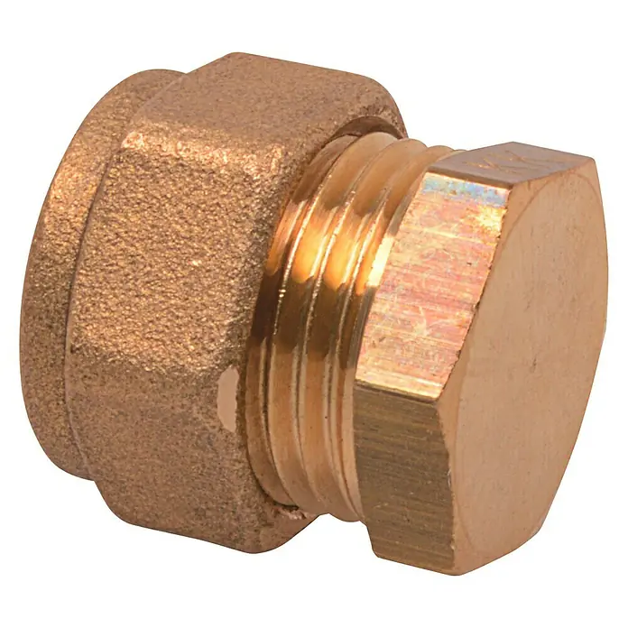 Verschlussstopfen Für Klemmringe - Durchmesser: 15 mm - Nahaufnahme eines goldenen Messingverschlusses mit Sechskantkopf auf schwarzem Hintergrund, der die Details des Produkts hervorhebt.
