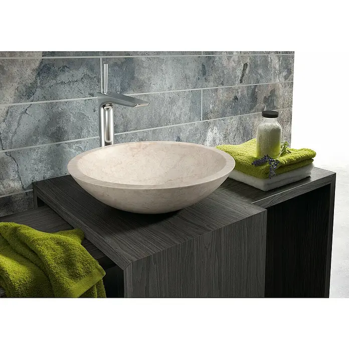 Bathco Lavabo de sobremesa Catania - Diámetro: 40,5 cm, Beige - Primer plano de un baño moderno con un elegante lavabo de piedra natural sobre un mueble de lavabo de madera oscura.